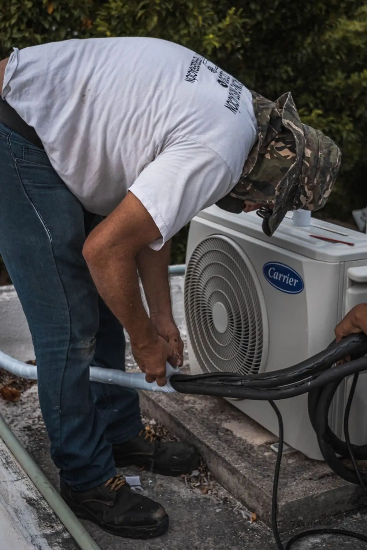 Technician servicing a rooftop air conditioning unit in the Bronx